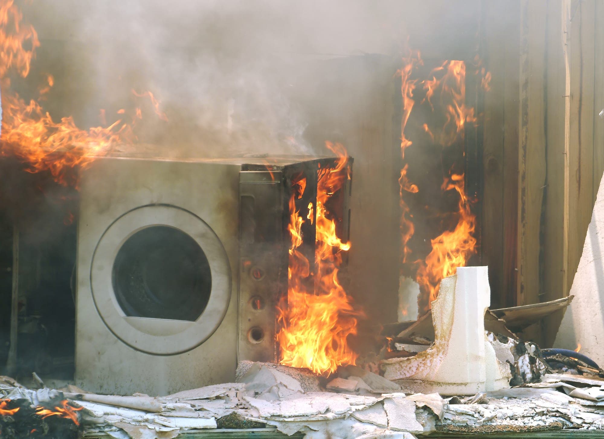 Clothes dryer engulfed in flames inside a burning room
