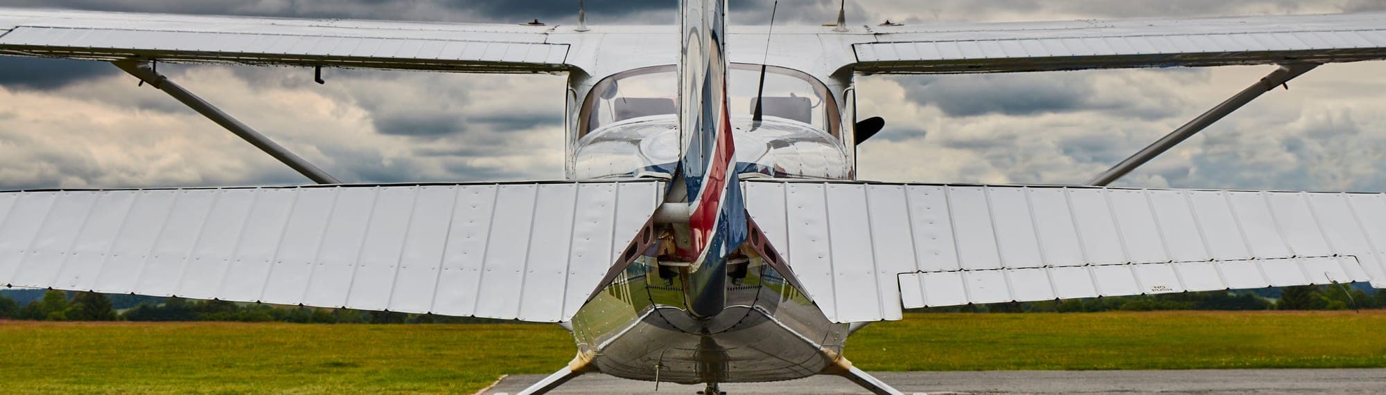Ground support tug parked beside a regional jet on the apron