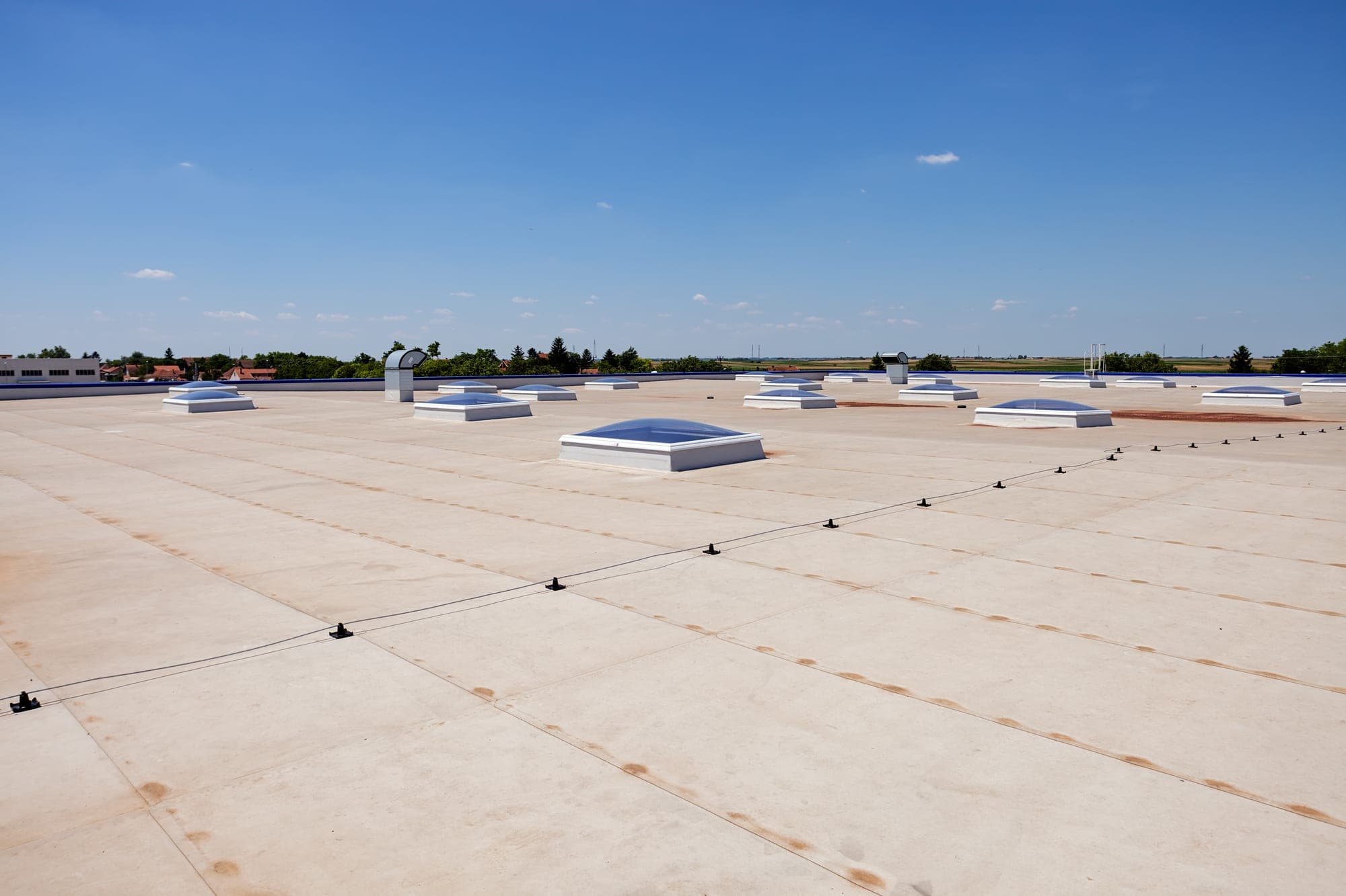 White single-ply membrane roof with domed skylights