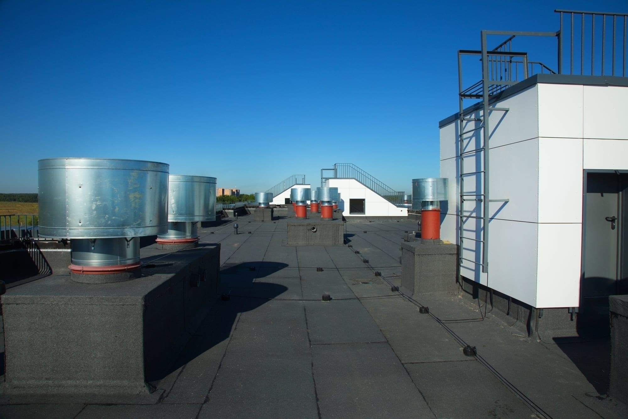 Flat bitumen membrane roof with metal ventilation units