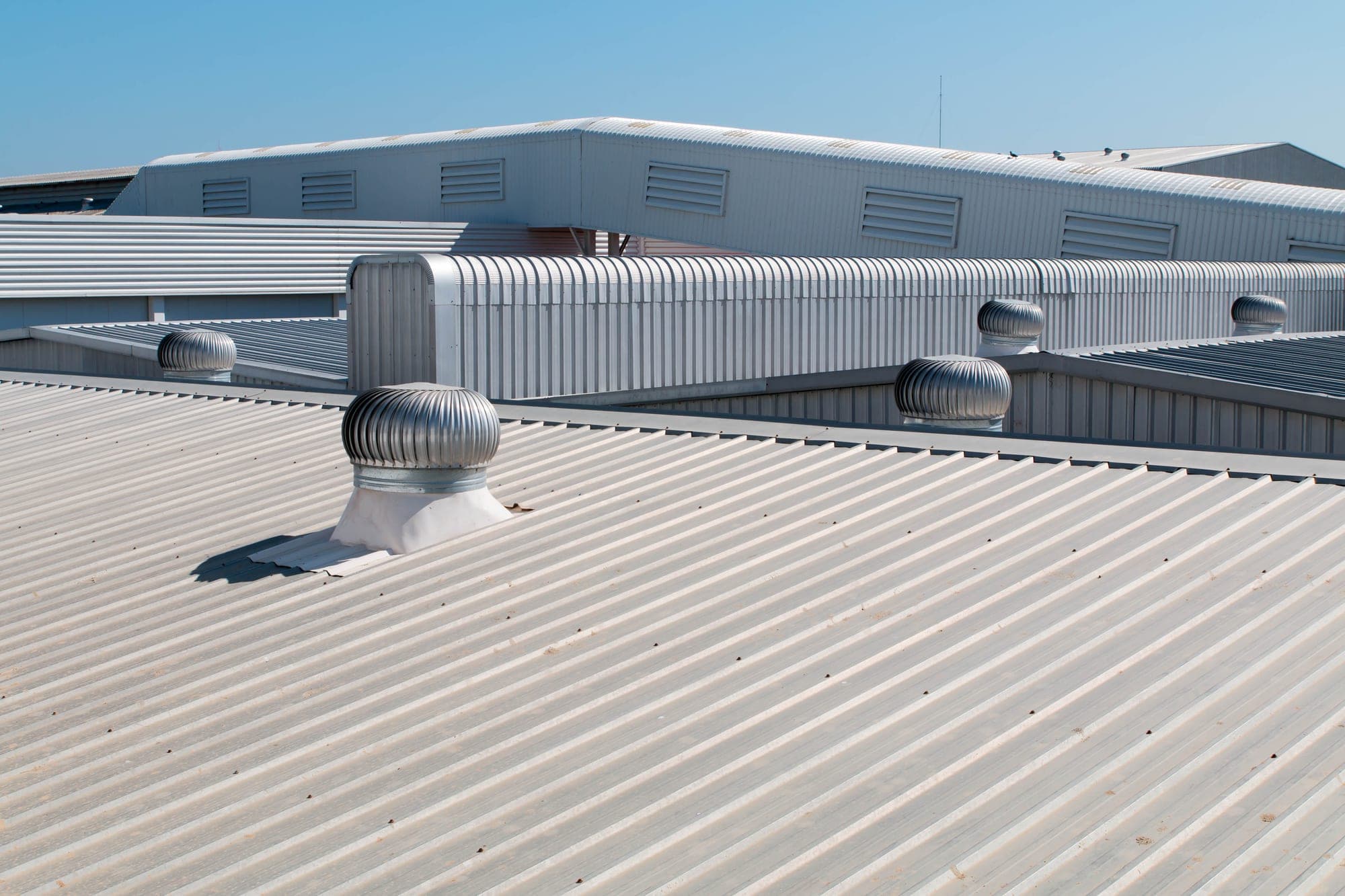 Corrugated metal commercial roof with turbine vents