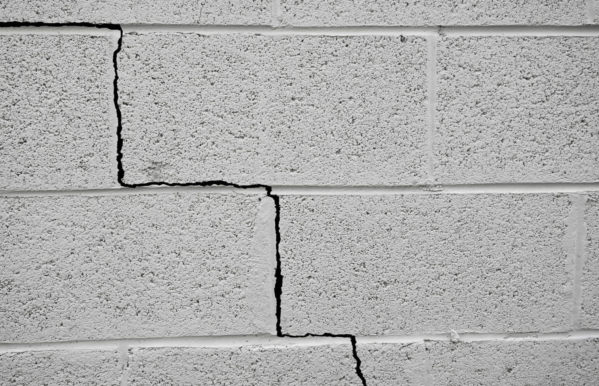 Stair-step crack running through a concrete block wall