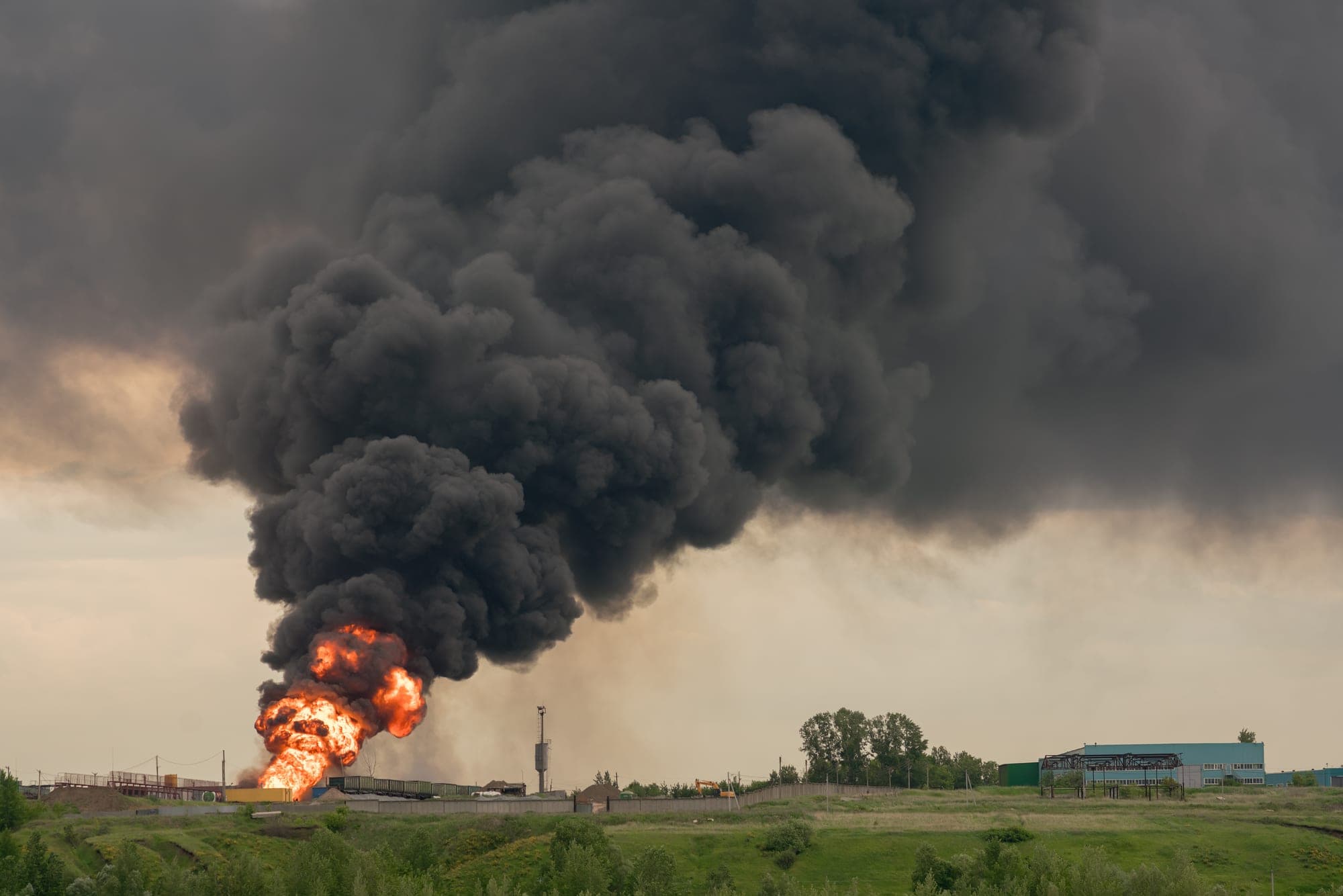 Fireball and black smoke plume rising from an industrial site