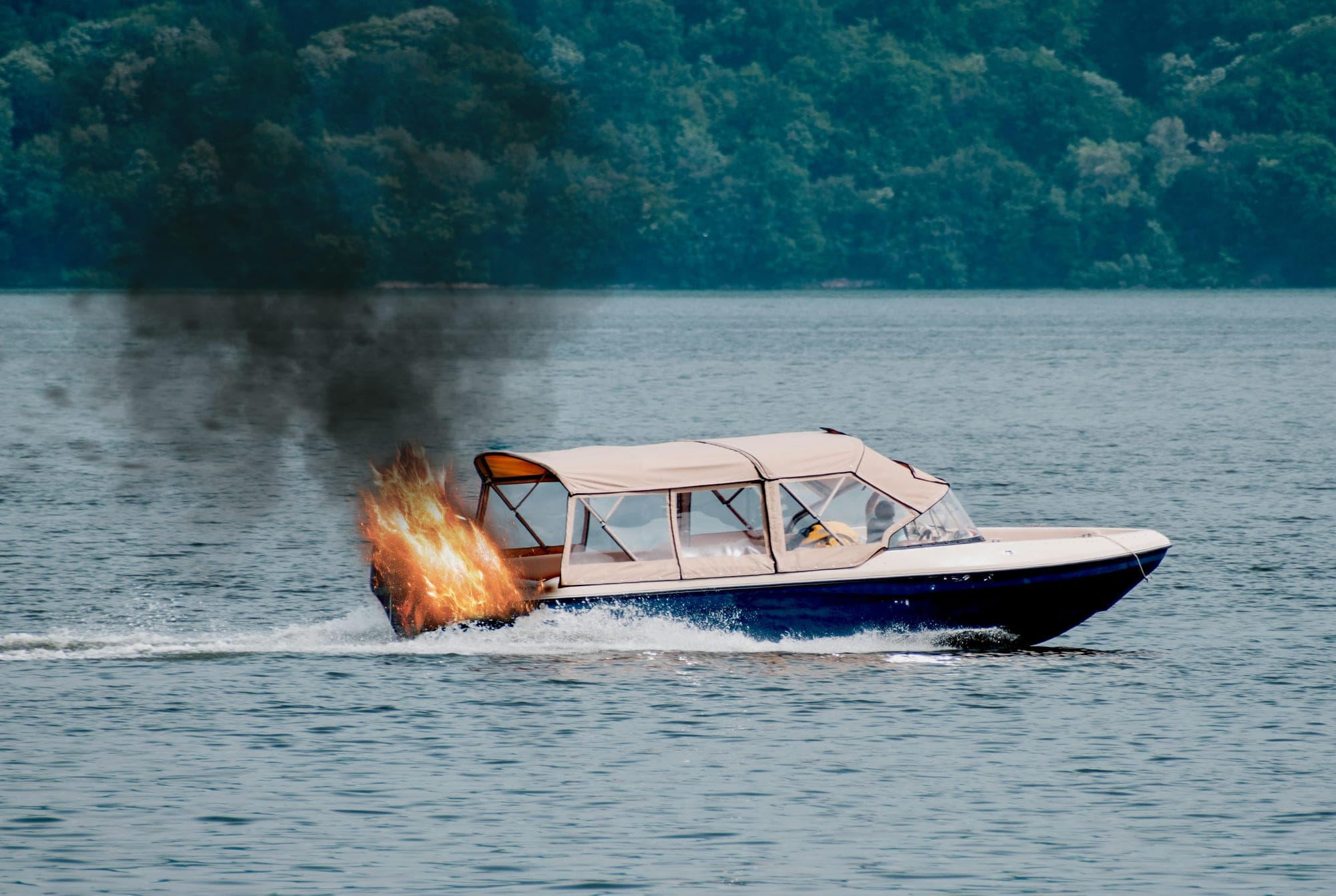 Motorboat on a lake with fire burning at the bow