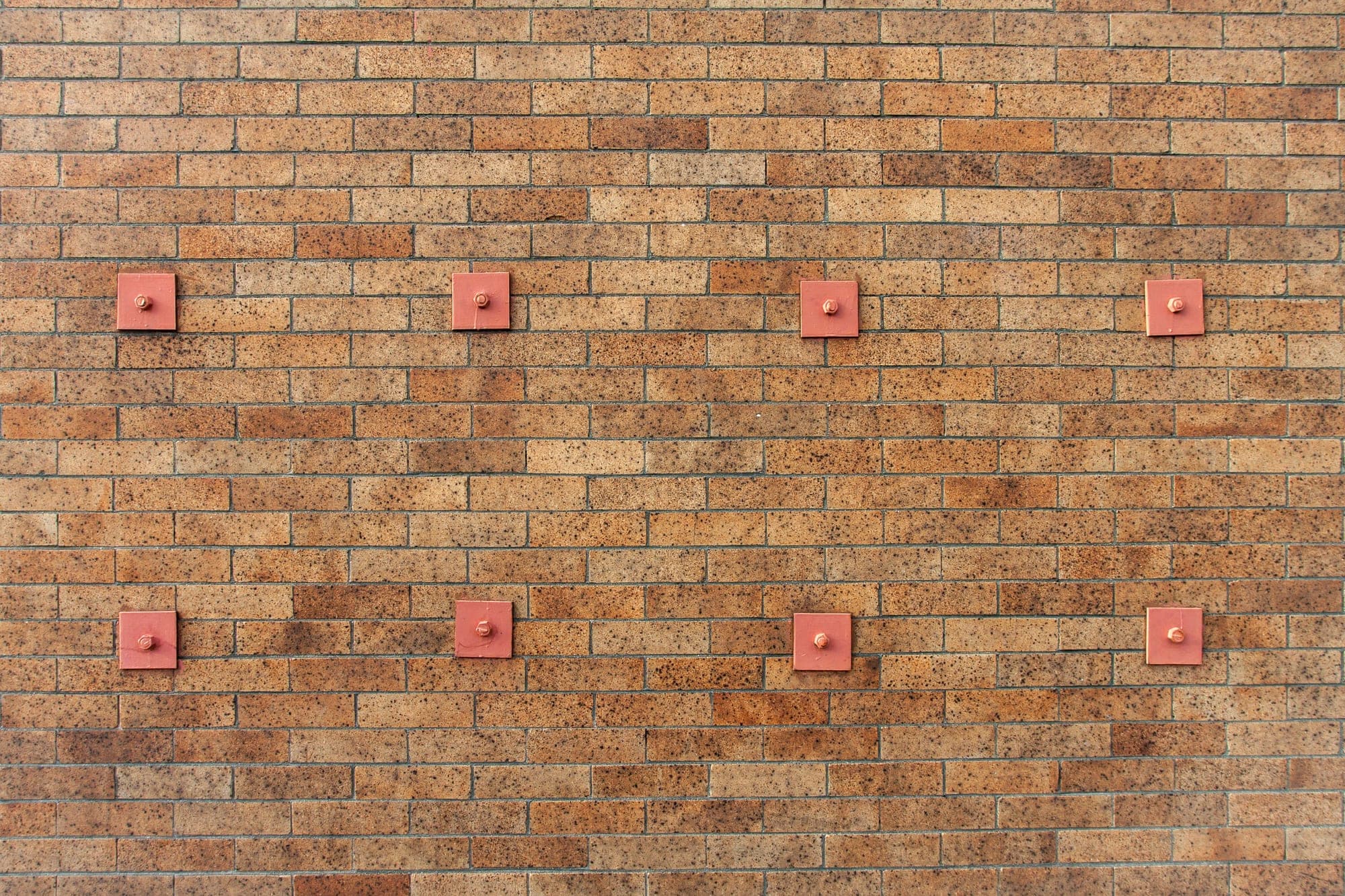 Brick wall fitted with steel structural anchor plates