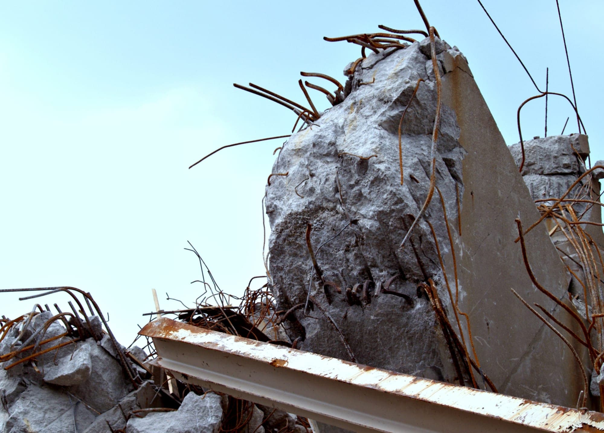 Broken reinforced concrete with exposed rusted rebar
