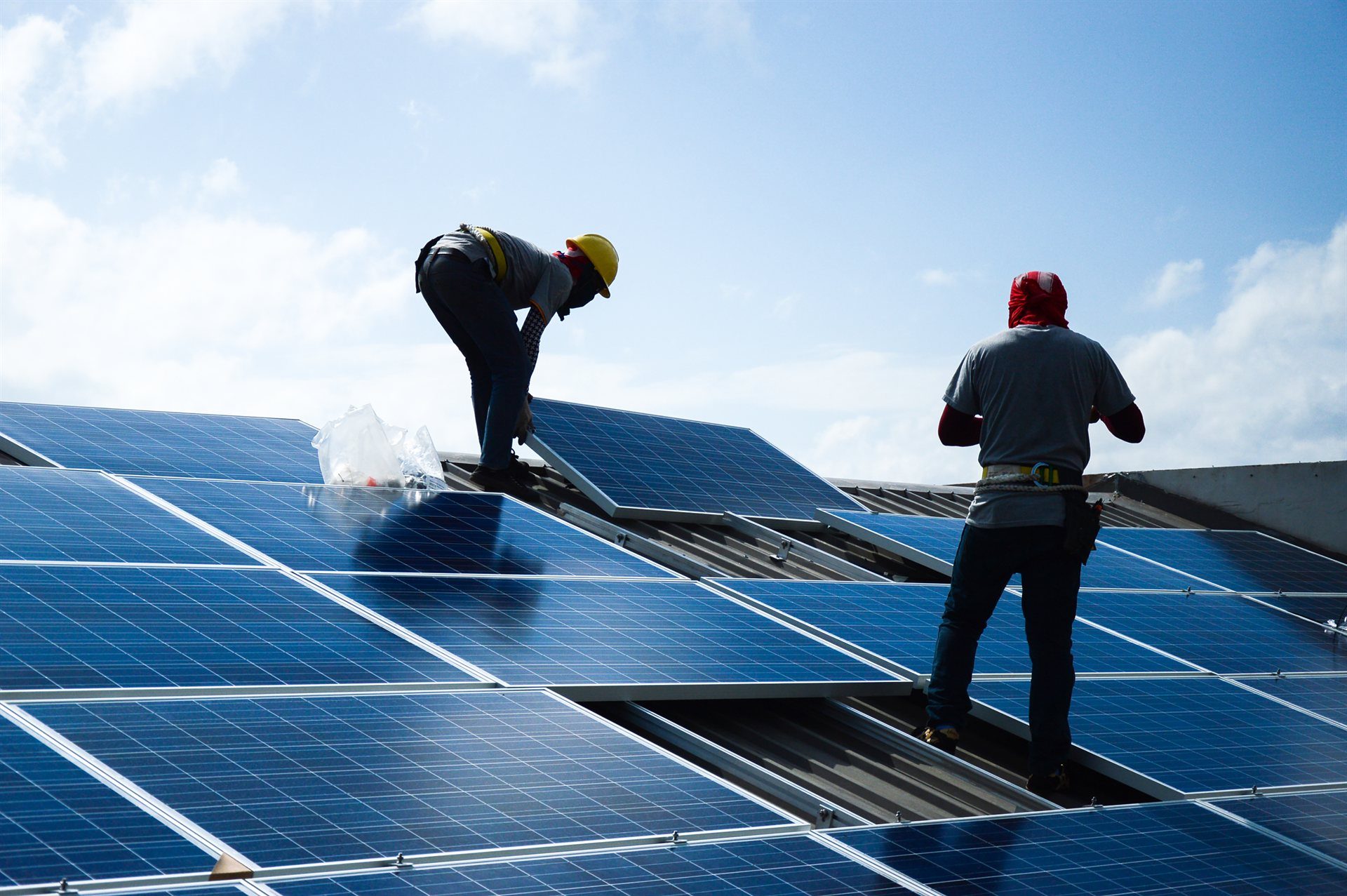 ESI investigator examining fire damage on a solar panel installation